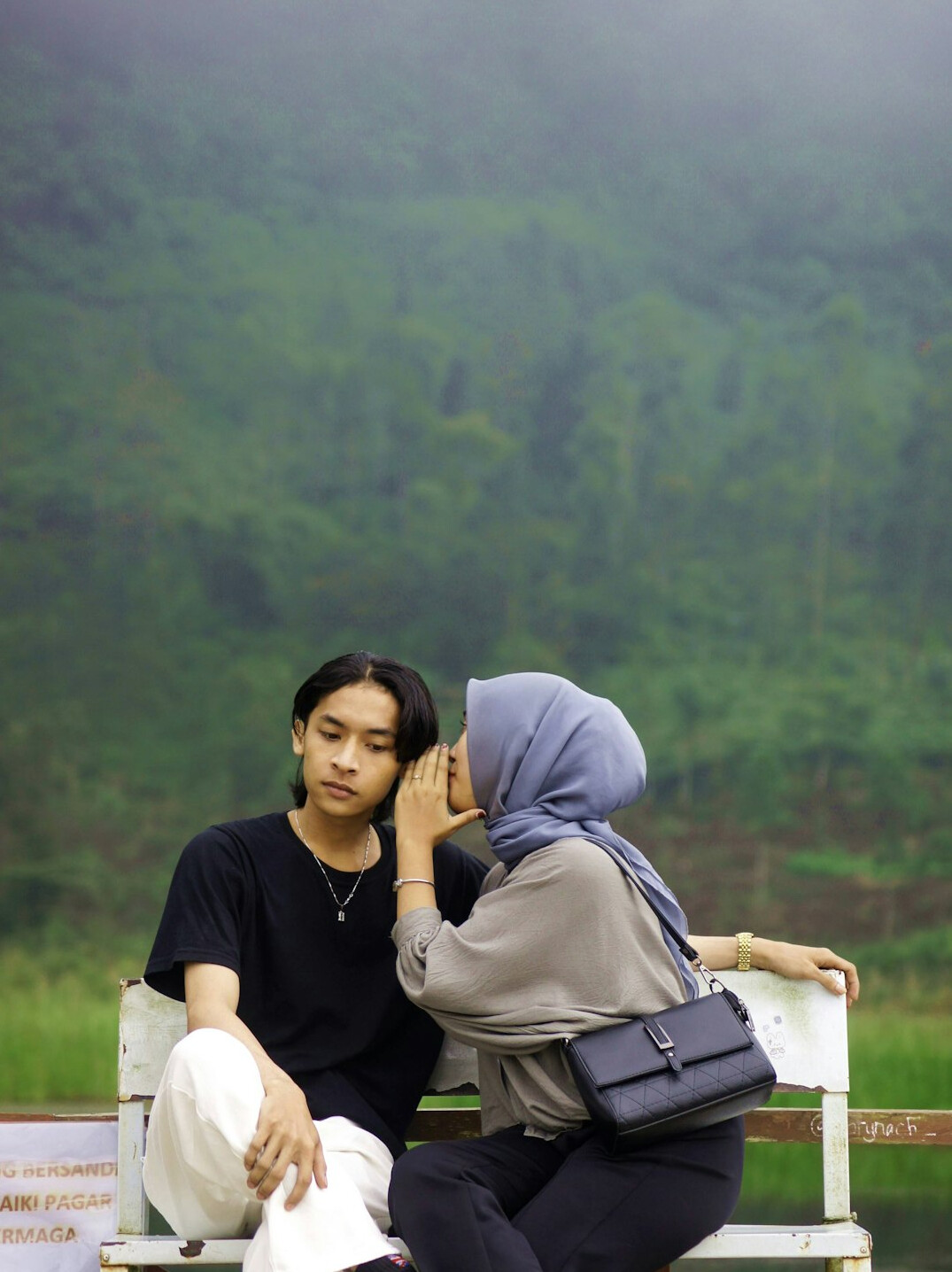 person whispering secret